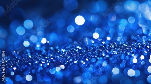 Sapphire glitter bokeh background. Unfocused shimmer royal blue sparkle. Crystal droplets wallpaper photo