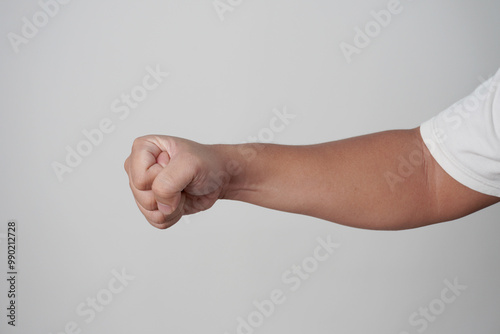 Εκτύπωση καμβά Male clenched fist, throwing punch, over grey