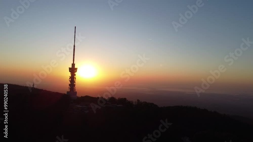 Early morning sunrise panorama of Sljeme above Zagreb with visible antenna tower, big massive hill and layers of fog below in valley. Epic panorama above zagreb photo