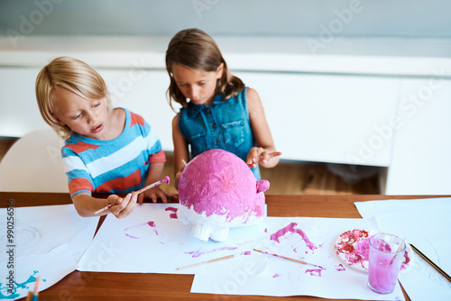 Painting, children and project in home for creativity, fun activity and design for arts and crafts. Messy, kids and creative on table for paper mache, DIY piggy bank and relationship development photo