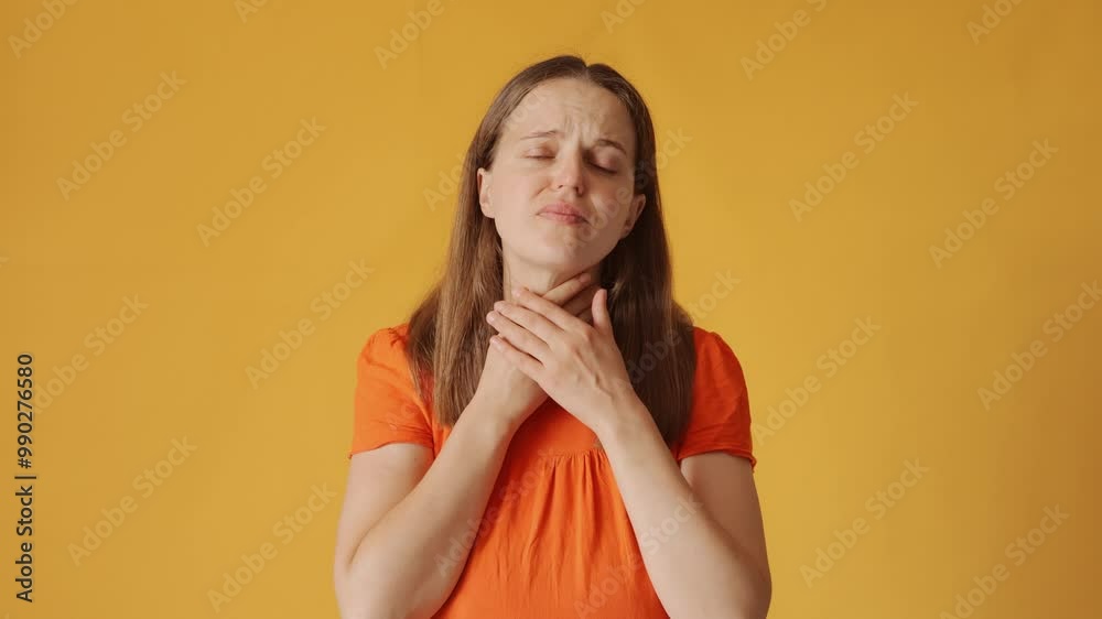Unwell woman with brown hair wearing orange shirt showing discomfort and pain in throat while dealing with illness and sore symptoms isolated over yellow background Unwell woman with brown hair wearing orange shirt showing discomfort and pain in throat while dealing with illness and sore symptoms isolated over yellow background