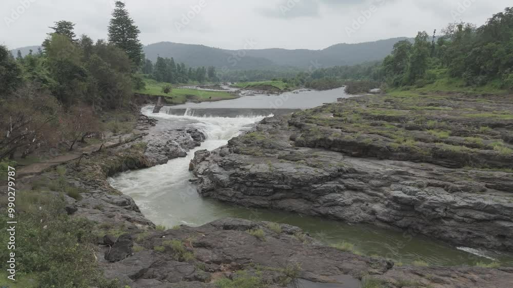Aerial view of river flowing through the rock area. Raw footage of Beautiful nature river water and forest. D log M footage without color grad. Aerial view of river flowing through the rock area. Raw footage of Beautiful nature river water and forest. D log M footage without color grad.