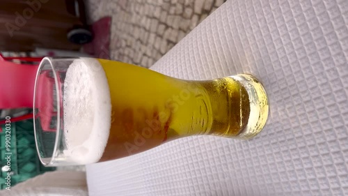 View of glass of beer on a table. Vertical format for social media photo