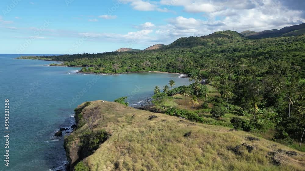 Aerial View Of Tropical Coastline With Grassy Forested Ridge Cliff Overlooking Turquoise Ocean, Comoros Islands Aerial View Of Tropical Coastline With Grassy Forested Ridge Cliff Overlooking Turquoise Ocean, Comoros Islands