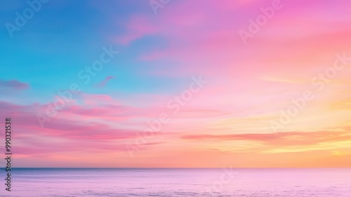 Beautiful sunset over the ocean, blending pink, orange, and blue hues in a serene coastal landscape.