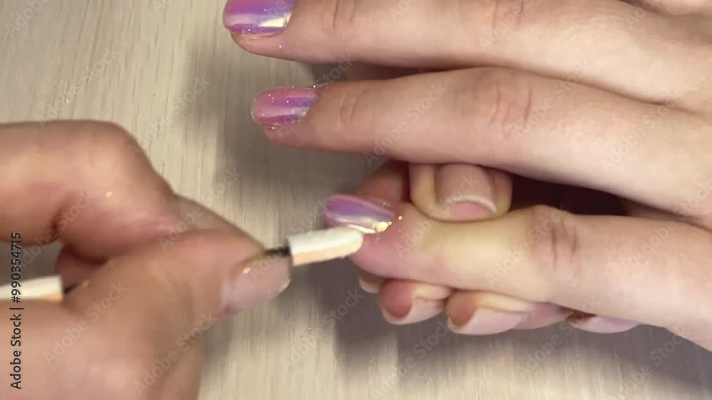Manicure, close-up manicurist rubs nails with chrome powder, trendy nail art design with shiny metallic coating, nail salon services Manicure, close-up manicurist rubs nails with chrome powder, trendy nail art design with shiny metallic coating, nail salon services