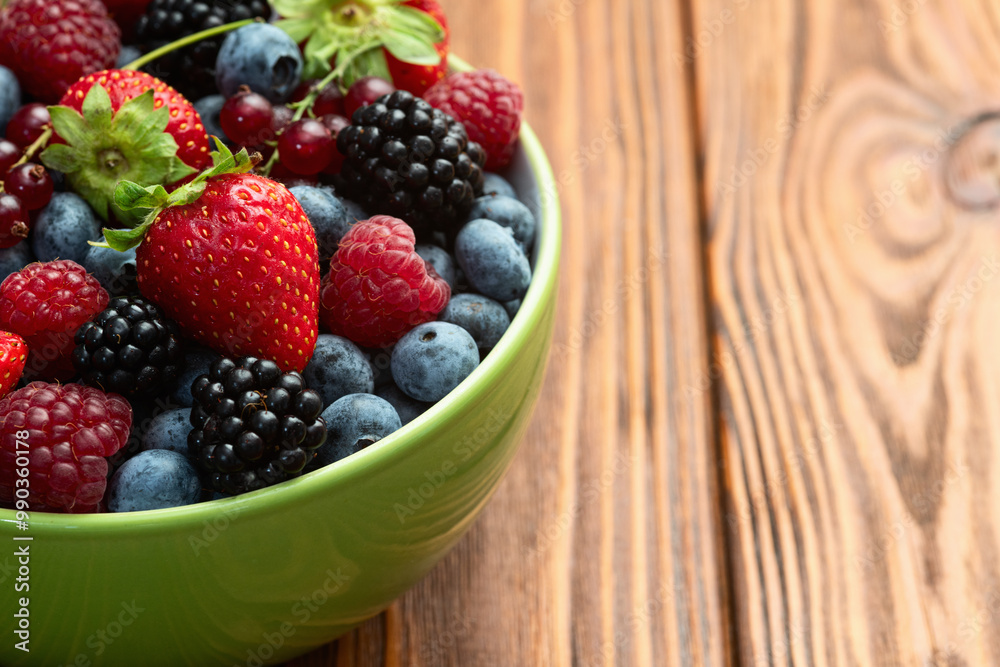 Mix of ripe colorful berries in bowl photography . Blueberry , strawberry , raspberry , blackberry and red currant . Top view Mix of ripe colorful berries in bowl photography . Blueberry , strawberry , raspberry , blackberry and red currant . Top view