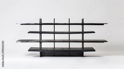 A sleek, black metal bookshelf with open shelves on a white background