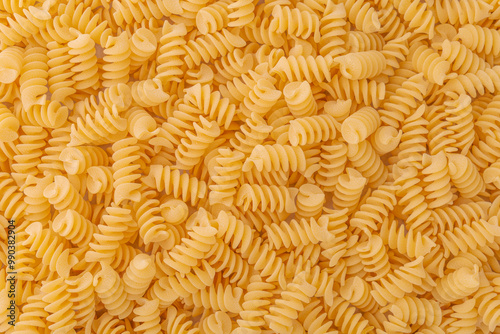 Spiral pasta background. Light wheat fusilli.