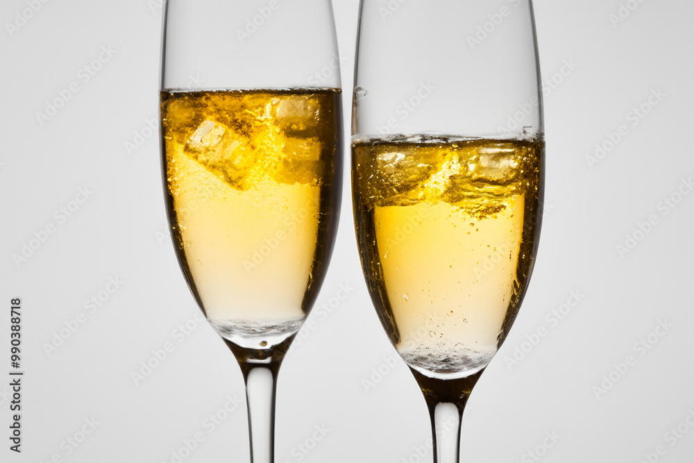 Glass of champagne with cubes on ice. drink beverage alcohol concept. a glass of champagne with ice cubes on a gray . a glass of champagne with ice cubes lifestyle on a gray. Glass of champagne with cubes on ice. drink beverage alcohol concept. a glass of champagne with ice cubes on a gray . a glass of champagne with ice cubes lifestyle on a gray.