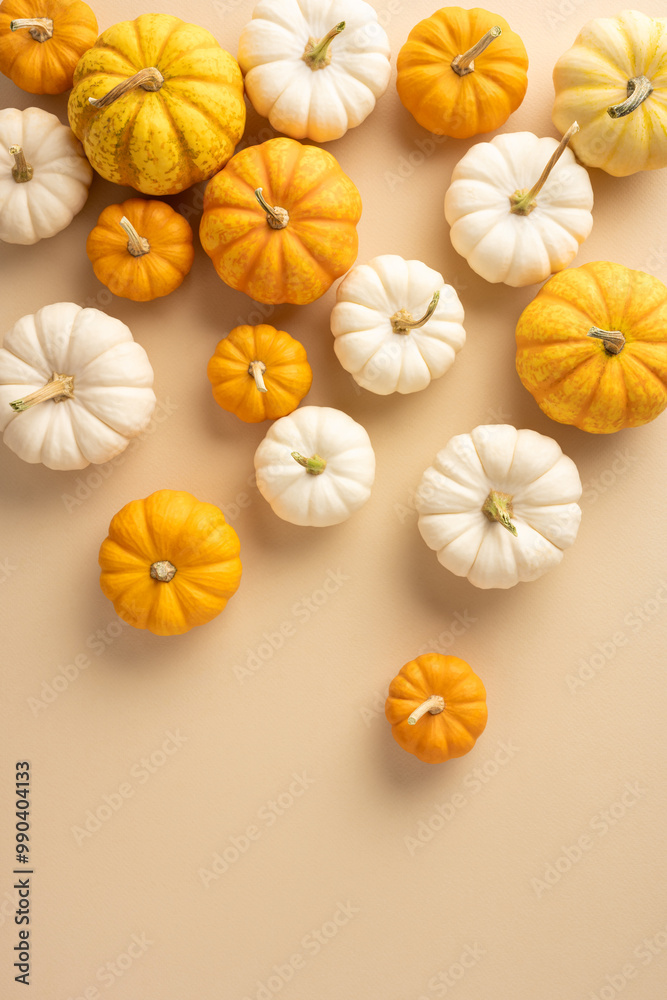 A collection of orange and white pumpkins scattered on a beige backdrop. Ideal for autumn, Thanksgiving, and seasonal themes with a warm, cozy feel A collection of orange and white pumpkins scattered on a beige backdrop. Ideal for autumn, Thanksgiving, and seasonal themes with a warm, cozy feel