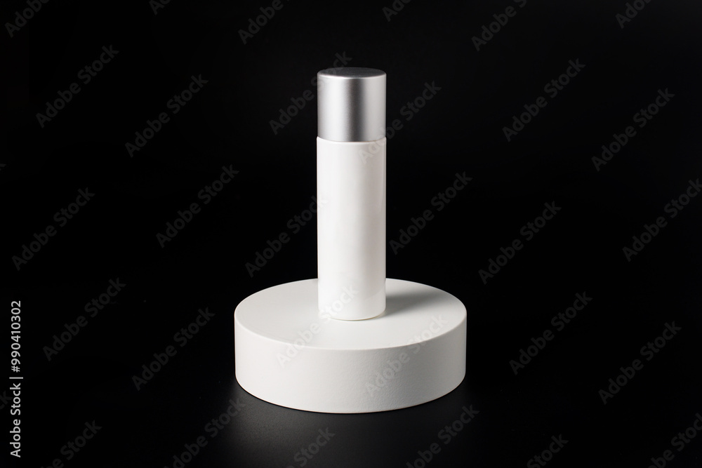 Plastic white tube for cream or lotion. Skin care or sunscreen cosmetic with stylish props on black background. Plastic white tube for cream or lotion. Skin care or sunscreen cosmetic with stylish props on black background.