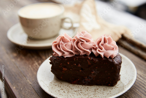 Aestetics vegan brownie witn no sugar cake dessert and cup of cappuccino outdoor at the snowy day. Coffee with dessert winter aesthetics. photo