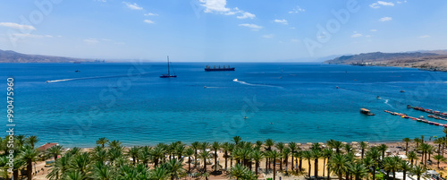 Panoramic view on the Aqaba gulf of the Red Sea and central public beach of E...
