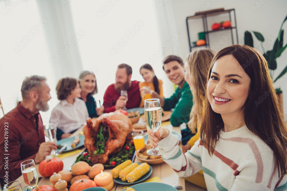 Fototapeta premium Photo of cheerful happy people relatives enjoying thanksgiving day sitting eating drinking indoors room home