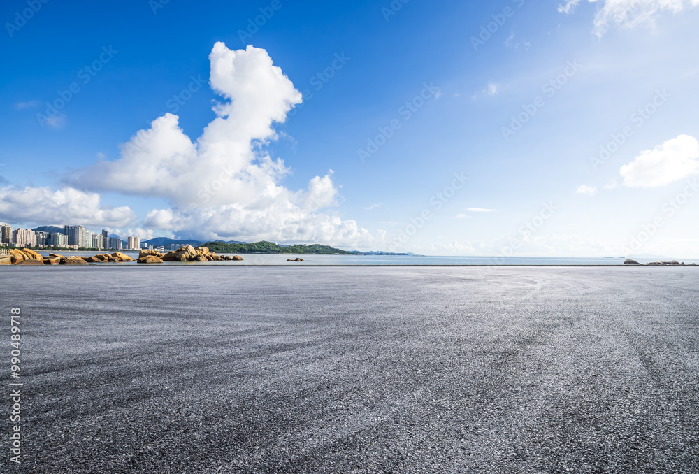 Asphalt road square and beautiful coastline with sky clouds nature background. car advertising background.