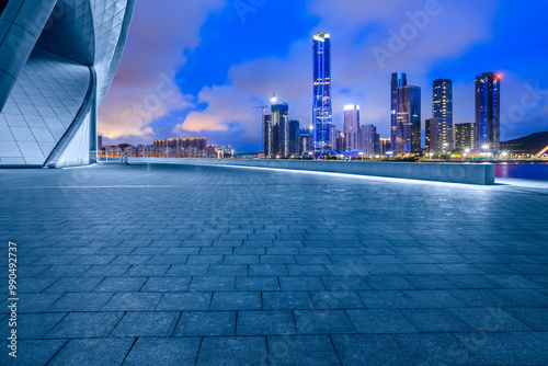 Empty square floors and city skyline with modern buildings scenery at night. car advertising background. photo