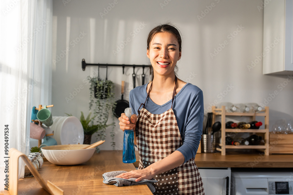 Portrait Asian cleaning service woman worker cleaning kitchen at home. Portrait Asian cleaning service woman worker cleaning kitchen at home.