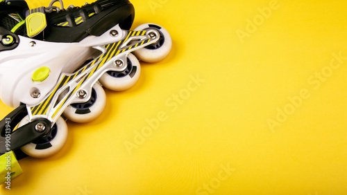 Obraz na plátně Stylish roller skates on yellow background, top view