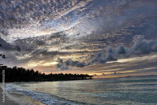 Enjoying the sunset on the beach that turns the clouds silver, it's so beautiful.