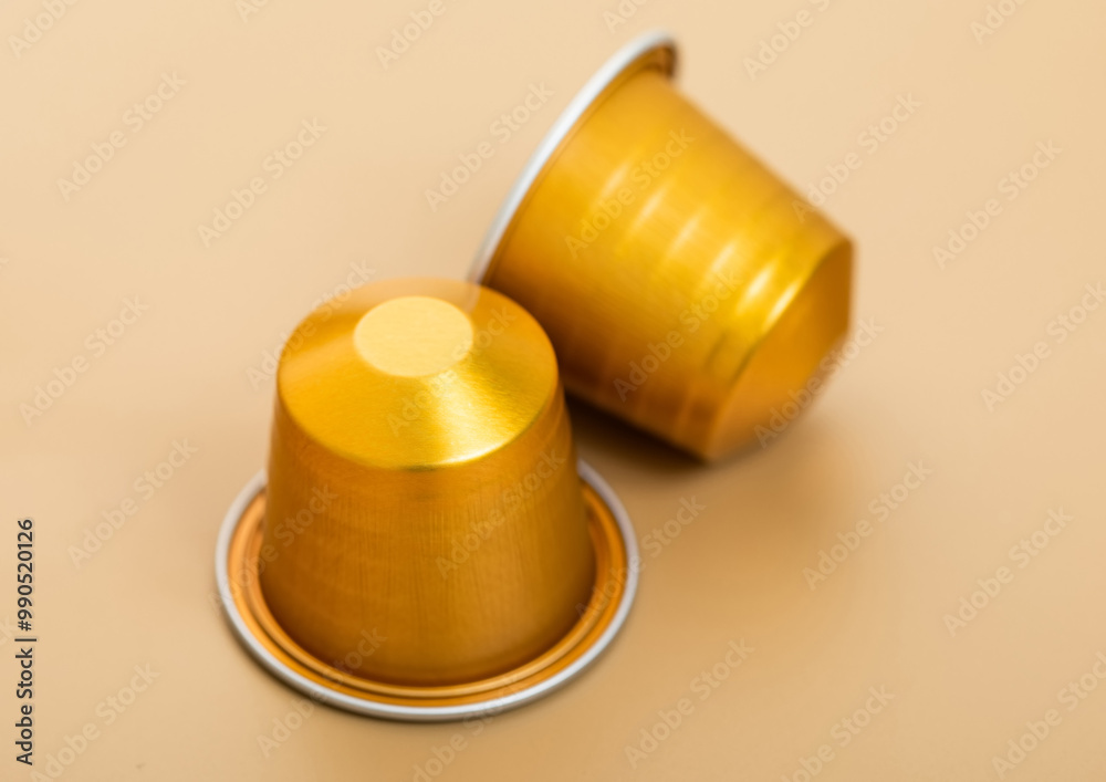 Aluminium coffee capsules pods for coffee machine on beige background. Aluminium coffee capsules pods for coffee machine on beige background.