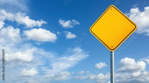 Blank yellow diamond road sign with a blue sky and white clouds.