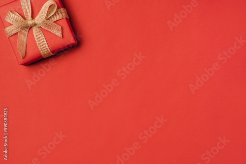 Gift boxe with bow on a red backdrop.