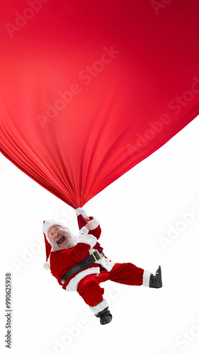 Hanging onto red fabric, Santa Claus, looking like jolly leprechaun, swinging into action, bringing mix of holiday fun and luck. Christmas, New Year, 2024. Poster, postcard, banner, flyer template photo