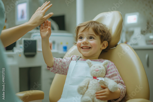 Happy child with toy smiling at dental office visit