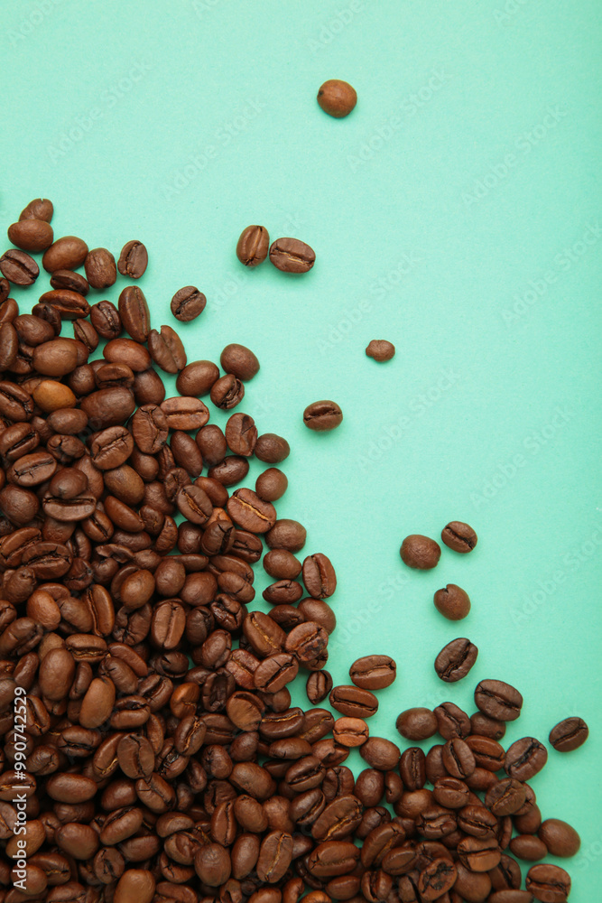 Obraz premium Roasted coffee beans on mint background. Space for text