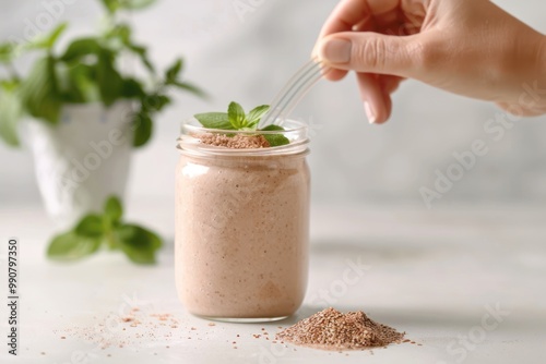 Obraz na płótnie Person adding flaxseed extract to a smoothie. w salonie