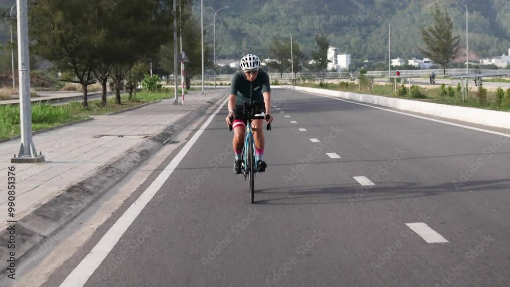 Female athlete joyfully rides her bicycle along scenic track. Female athlete joyfully rides her bicycle along scenic track.