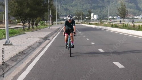 Wallpaper Mural Female athlete joyfully rides her bicycle along scenic track. Torontodigital.ca