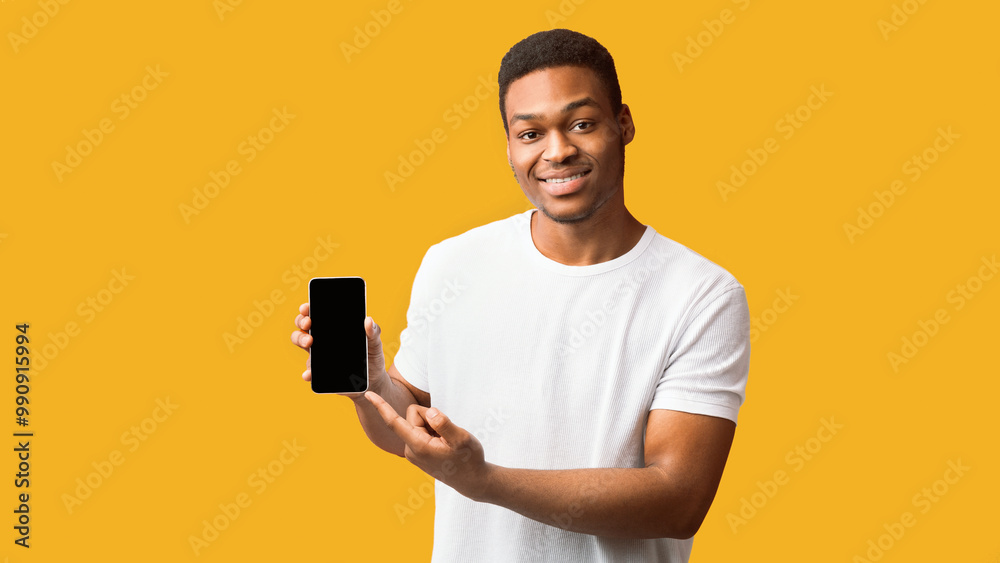 Useful App Or Website. Black man pointing at blank cell phone screen for advertising text, empty space, mock up Useful App Or Website. Black man pointing at blank cell phone screen for advertising text, empty space, mock up
