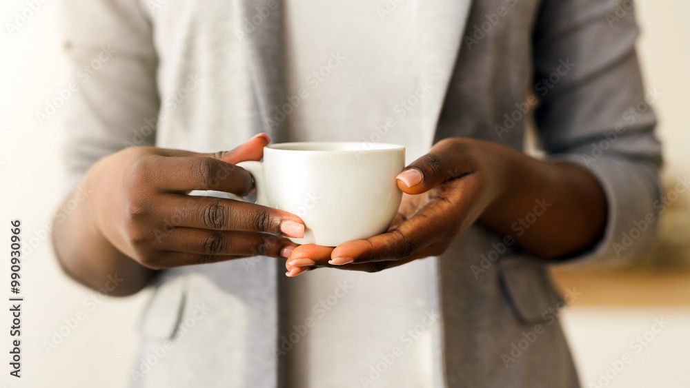 Cup of coffee in hands of unrecognizable african american businesswoman, closeup Cup of coffee in hands of unrecognizable african american businesswoman, closeup