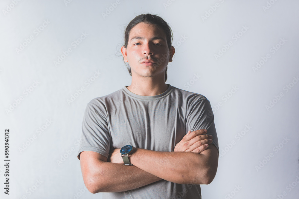 Portrait of handsome latin guy with crossed arms on isolated background Portrait of handsome latin guy with crossed arms on isolated background