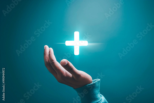 Male hand holding plus icon on blue background. Plus sign virtual means to offer positive thing like benefits, personal development, social network Profit,health insurance, growth concepts