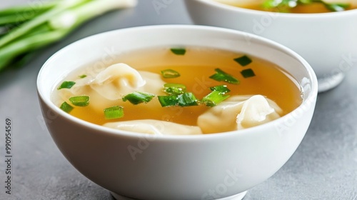 Fresh Dumpling Soup with Green Onions in Bowls