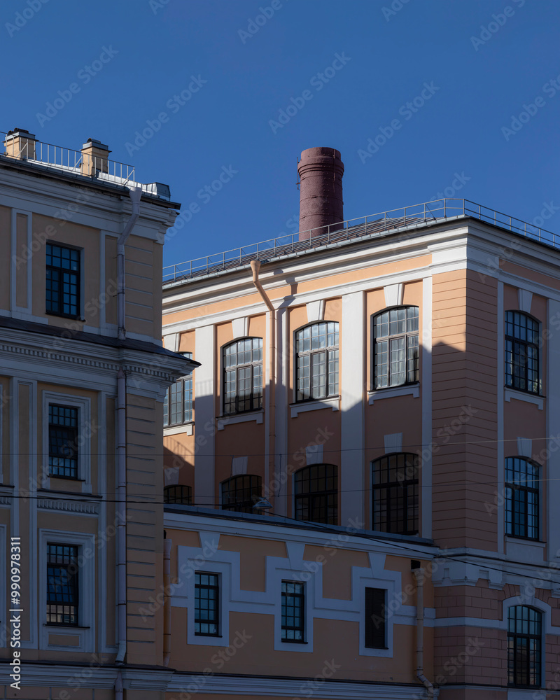 Obraz premium Historic paper mill building and brick chimney in the old part of St. Petersburg, Russia.