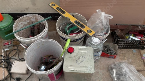 messure Inverter welding machine, welding equipment, set of accessories for arc welding,a lot of tools scattered randomly on a bucket in a mechanic's workshop photo