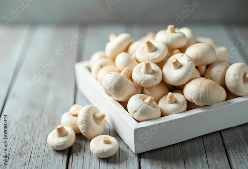 White Mushrooms in a White Box on a Wooden Table photo