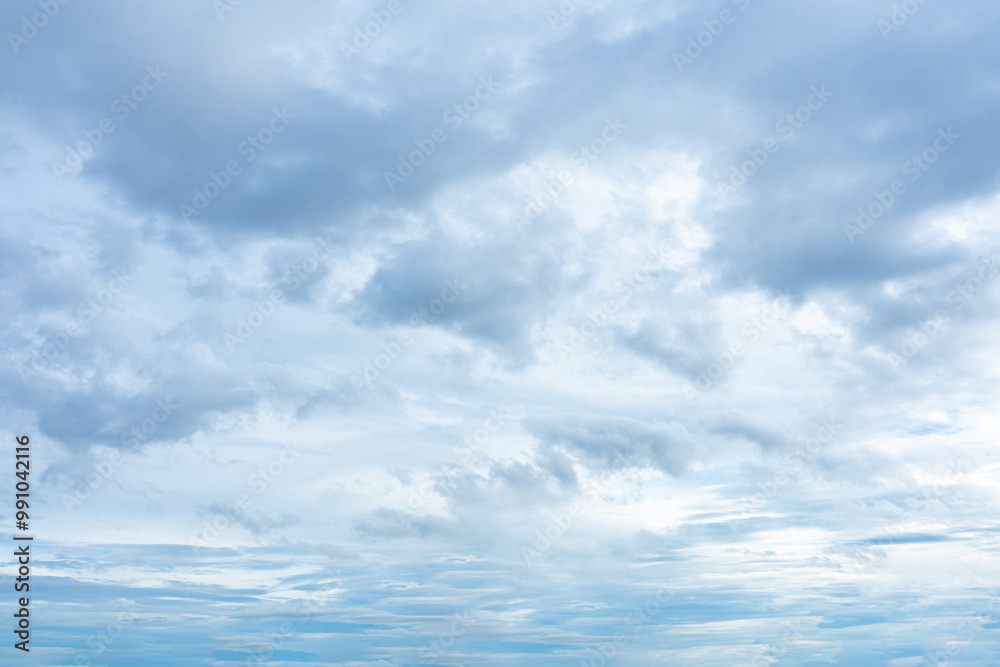 Fluffy white clouds drift across a vibrant blue sky, creating a breathtaking natural spectacle Fluffy white clouds drift across a vibrant blue sky, creating a breathtaking natural spectacle