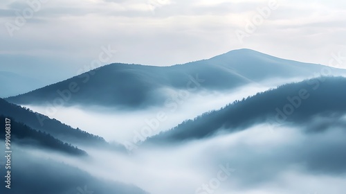 background with misty hills in the early morning, featuring fog-covered slopes and a tranquil, soft light