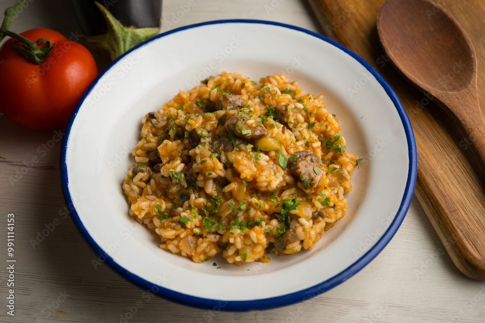 Rice paella with Iberian pork cheek. Traditional spanish tapa with iberic pork. Rice paella with Iberian pork cheek. Traditional spanish tapa with iberic pork.