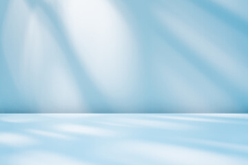 Abstract blue background for product presentation with sunlight and blurred shadows wall. Winter background.

