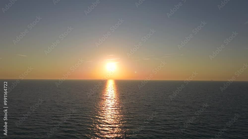 forward climbing aerial drone 4K film of sailboat yacht sailing on sea ocean water with Dutch holland flag at sunrise sunset silhouette forward climbing aerial drone 4K film of sailboat yacht sailing on sea ocean water with Dutch holland flag at sunrise sunset silhouette