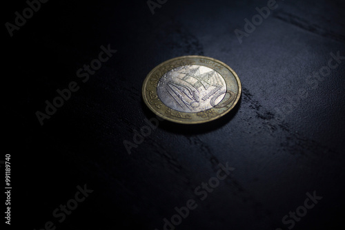 Back of a 10 moroccan dirham coin over a black background photo