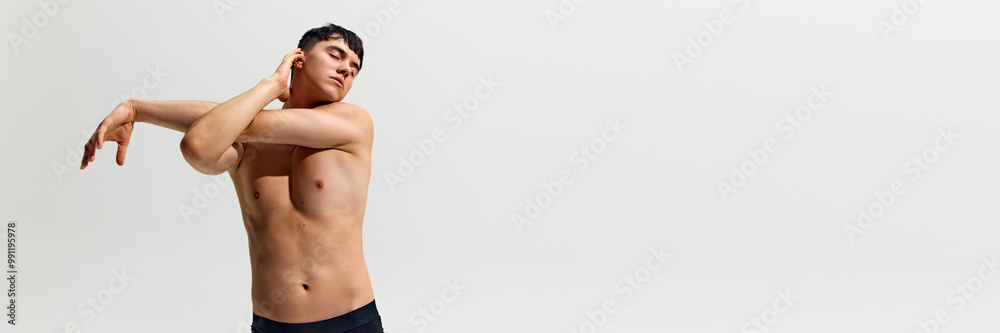 Fototapeta premium Portrait of handsome and confident young man posing shirtless, showing his perfect muscular body isolated on white studio background. Concept of male beauty, body and skin care, health, sport. Banner