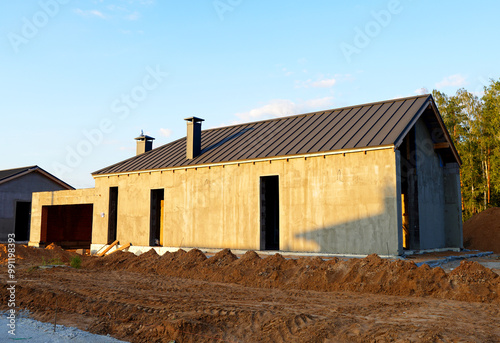 Barn House construction. Barnhouse building in forest. Modern Family house construction. Cottage Scandi Barn home in suburb. Barndominium construction. Construction of sustainable house in rural.