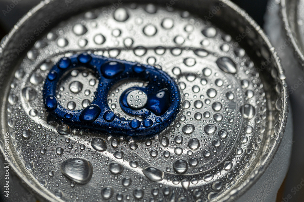 Close-up of an aluminum beverage can covered in condensation droplets. The blue pull tab and silver metallic surface are highlighted, emphasizing coldness and refreshment.
Close-up of an aluminum beverage can covered in condensation droplets. The blue pull tab and silver metallic surface are highlighted, emphasizing coldness and refreshment.